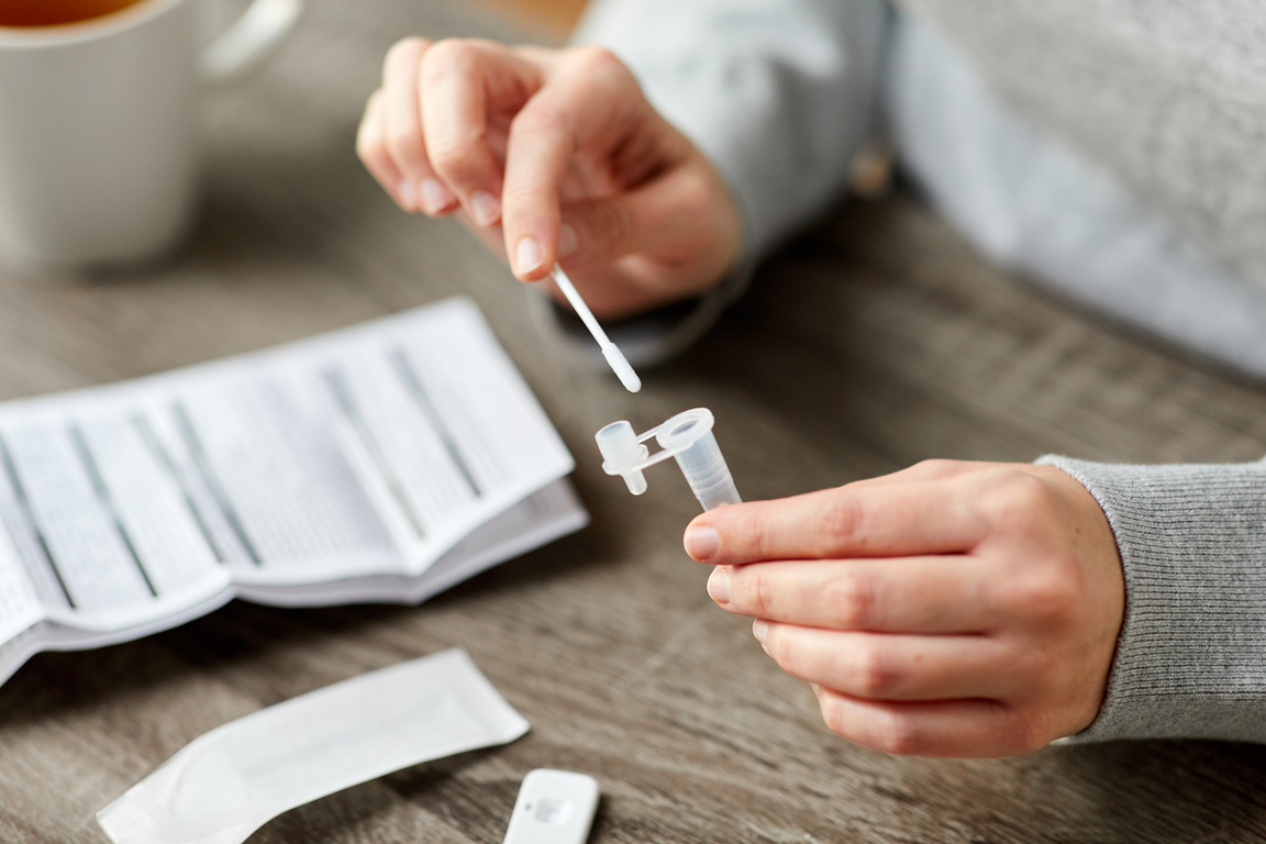 Woman Making Self Testing Coronavirus Test at Home