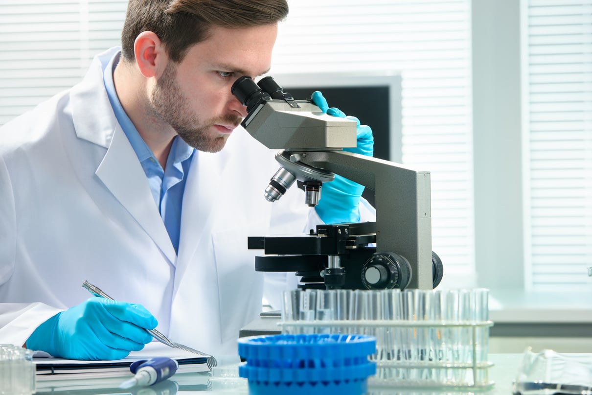 Scientist looking through a microscope